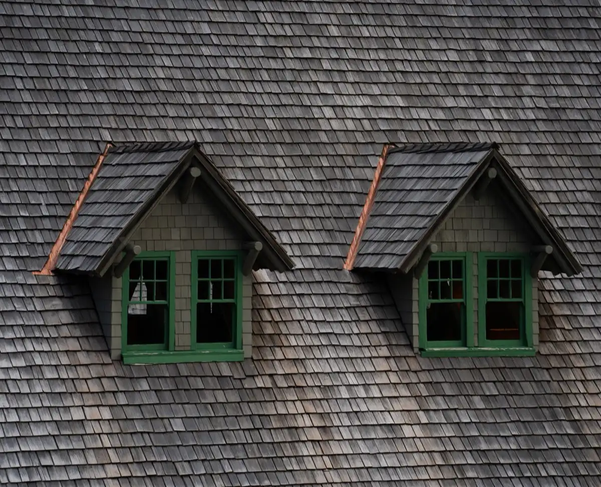 Dormers on a shingle roof in Shreveport, LA, where step flashing and kickout flashing carry water past the walls